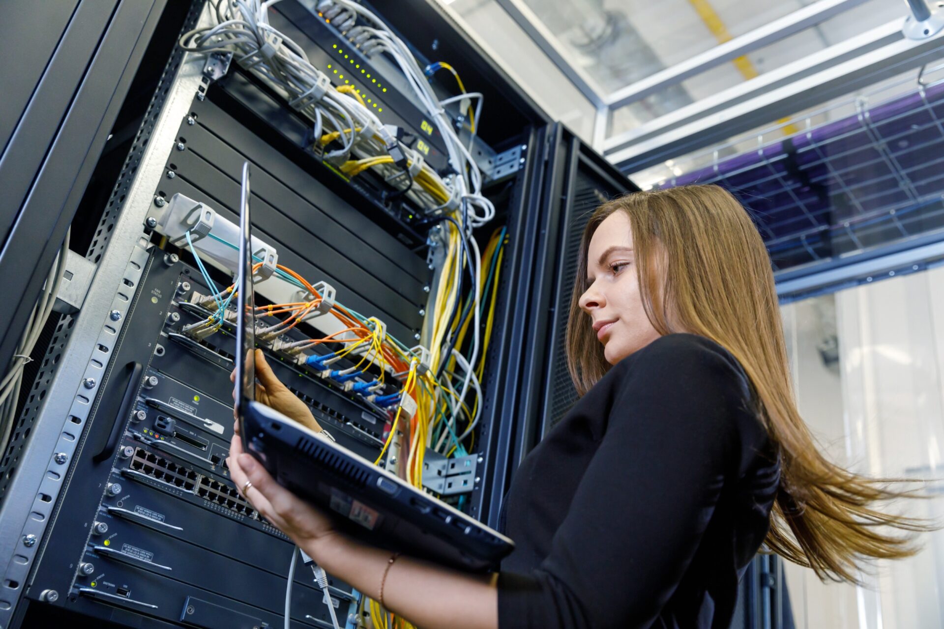 Young woman engineer at the network equipment